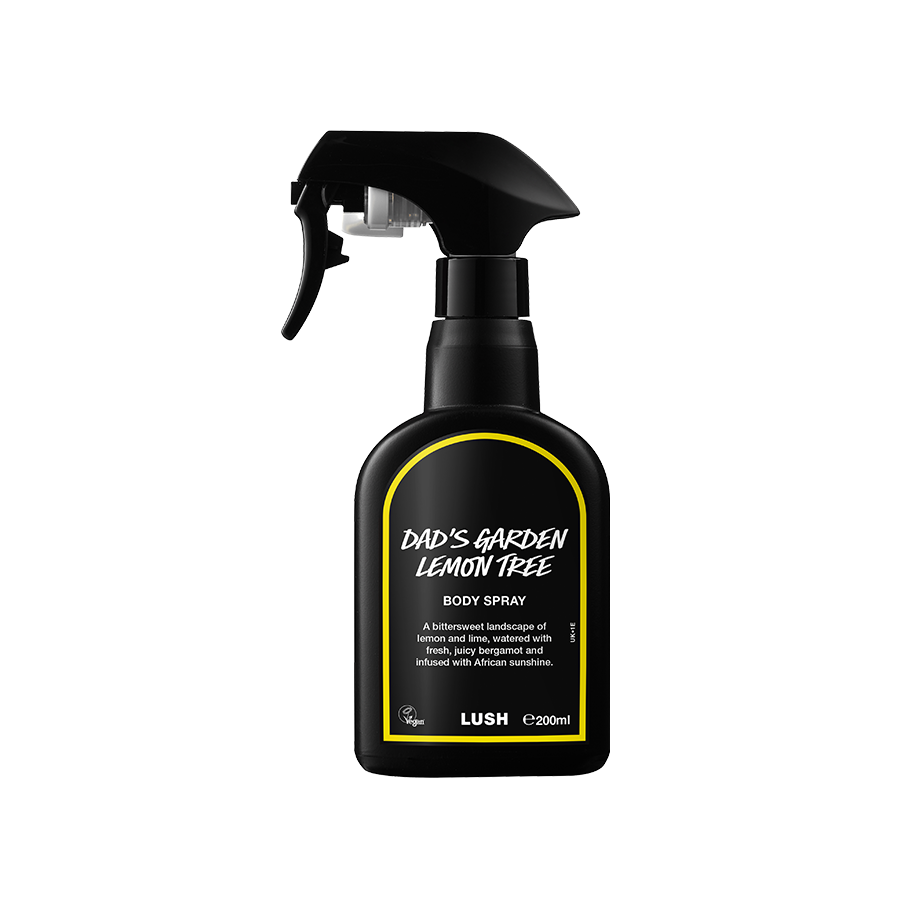 Dad's Garden Lemon Tree body spray. A black spray bottle of Lush "Dad's Garden Lemon Tree" Body Spray. The product label is black with a vibrant, dandelion-yellow banded border. White text states the product name and the scent description.
