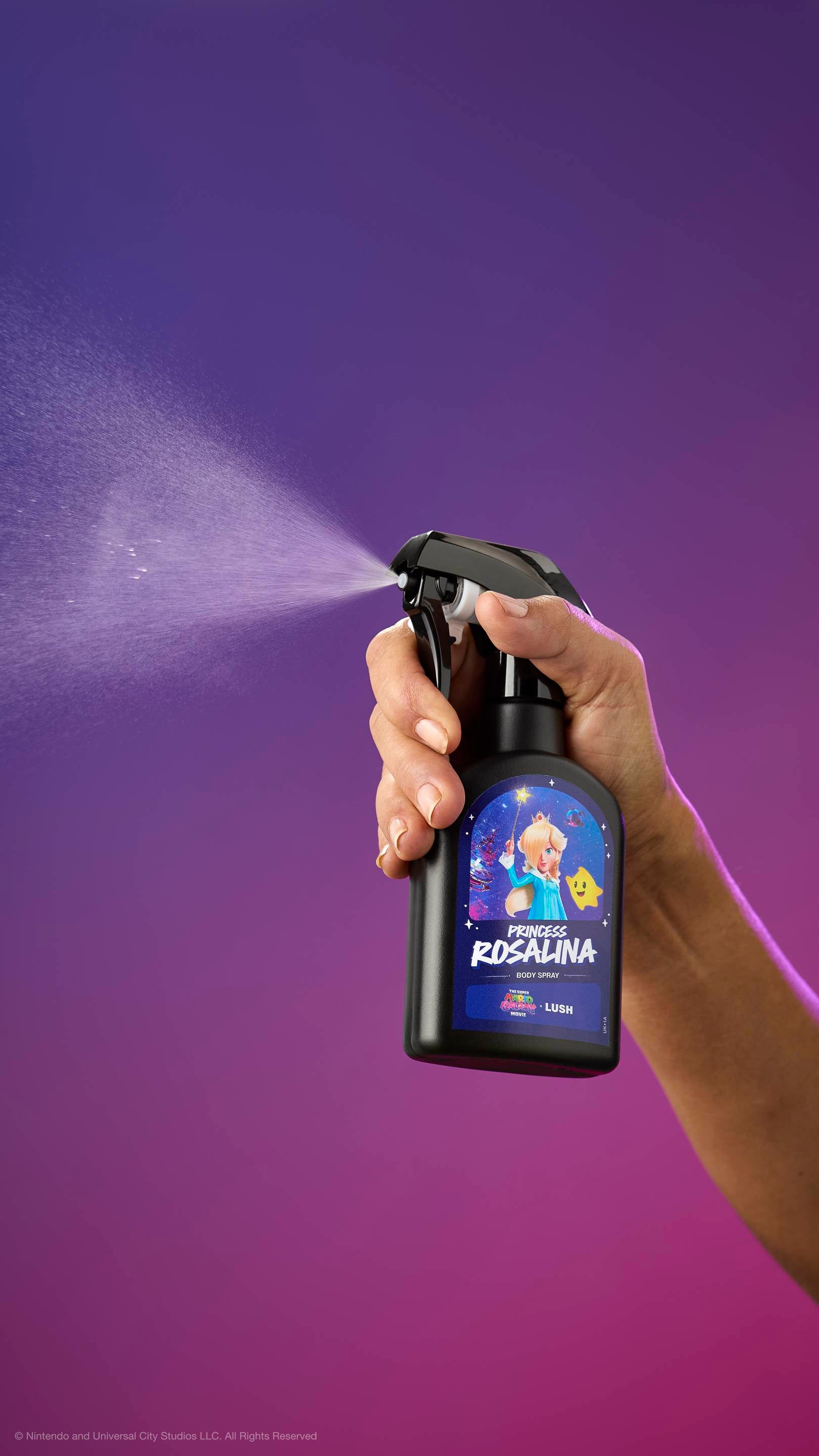Hand sprays black Princess Rosalina body spray bottle against a purple-magenta gradient. Label features Princess Rosalina and a Luma. Movie and LUSH logos visible at the top.