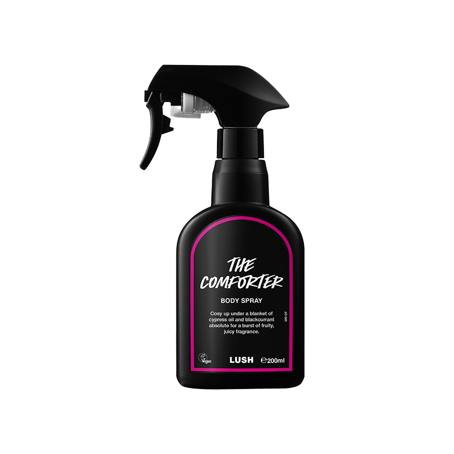 The Comforter body spray. A black spray bottle of Lush "The Comforter" Body Spray. The product label is black with a hot pink banded border. White text states the product name and the scent description.
