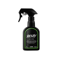 Zesty body spray. A black spray bottle of Lush "Zesty" Body Spray. The product label is black with a bright green banded border. White text states the product name and the scent description.