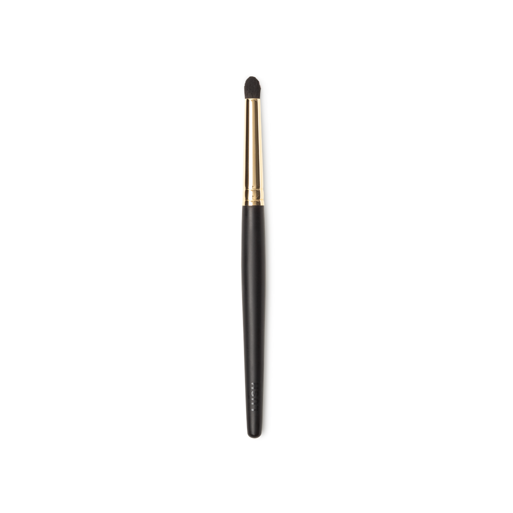 Blur In Love Brush. A small pencil brush, with circular brown bristles and a gold and dark wooden handle.