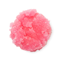 Bubblegum. A neatly piled swatch of thick, textured, vibrant pink lip scrub with visible sugar granules.