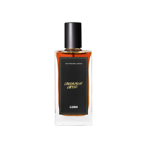 A glass perfume bottle filled with mahogany liquid. A black label reads 'The Perfume Library' and 'Cardamom Coffee'.