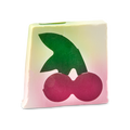 Cherry On Top. An off-square slice of cream-coloured soap which features a cross-section design of a large dark pink cherry with a large green leaf.
