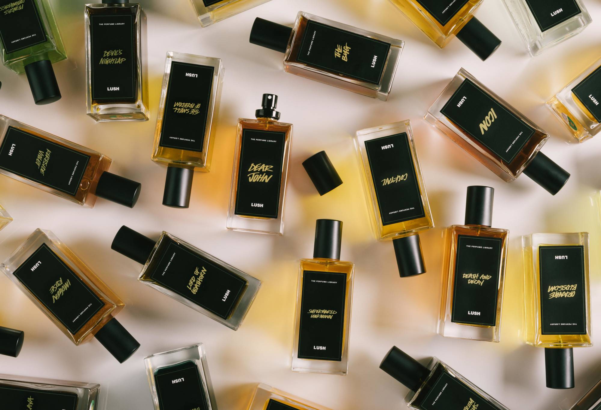 A number of black label perfume bottles are arranged randomly, with Dear John in the centre, lid off, ready to spritz.