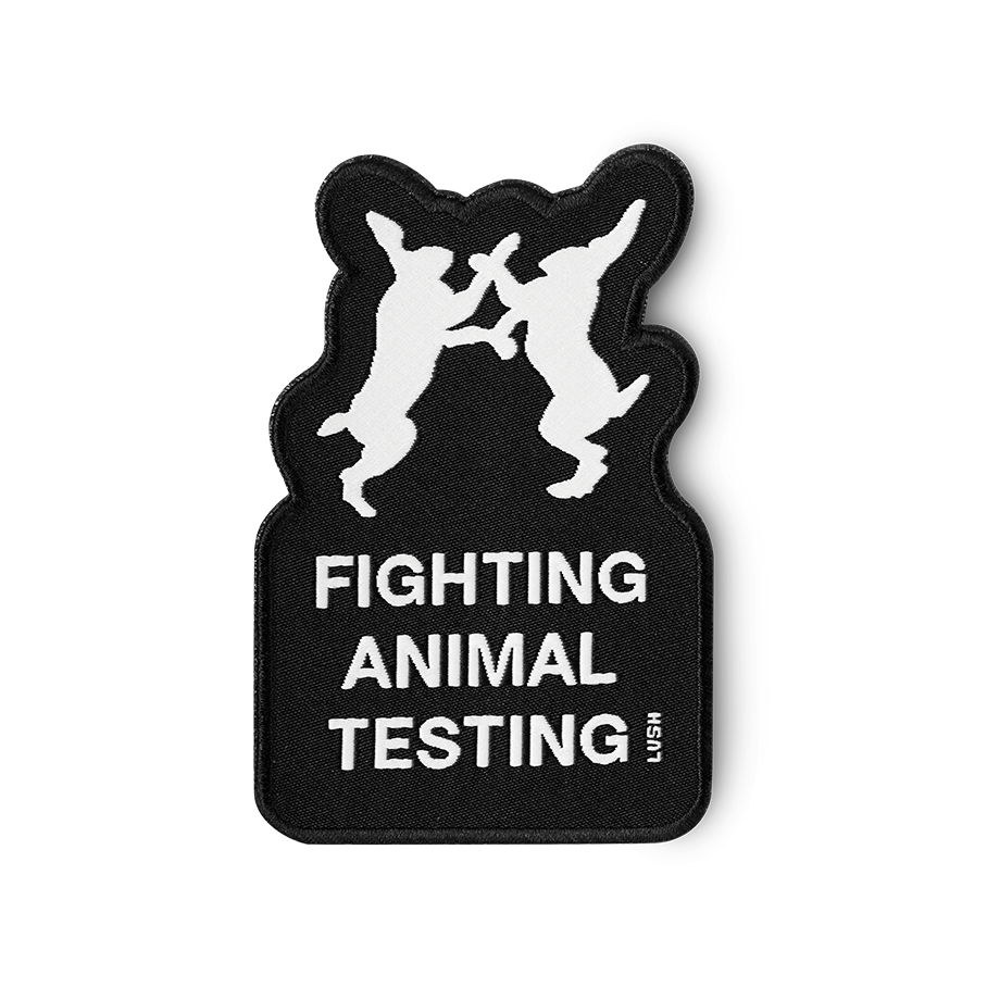 Iron-on patch is shaped around the fighting bunny logo and detailed in black with "Fighting Animal Testing" text in white.
