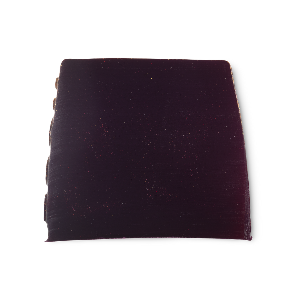 Goddess. A deep purple, smooth, trapezium shaped soap, with a touch of shimmer, and bumps along its left side.