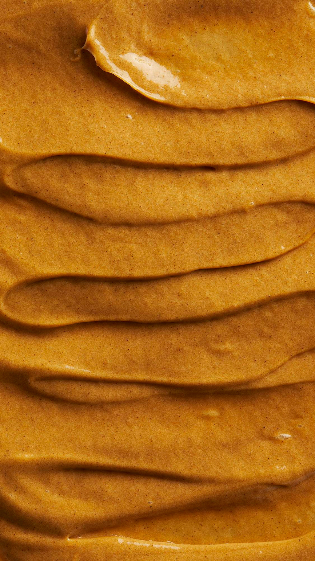 Image is a very defined close-up of the thick, batter-like golden-brown hot oil treatment spread over the screen.