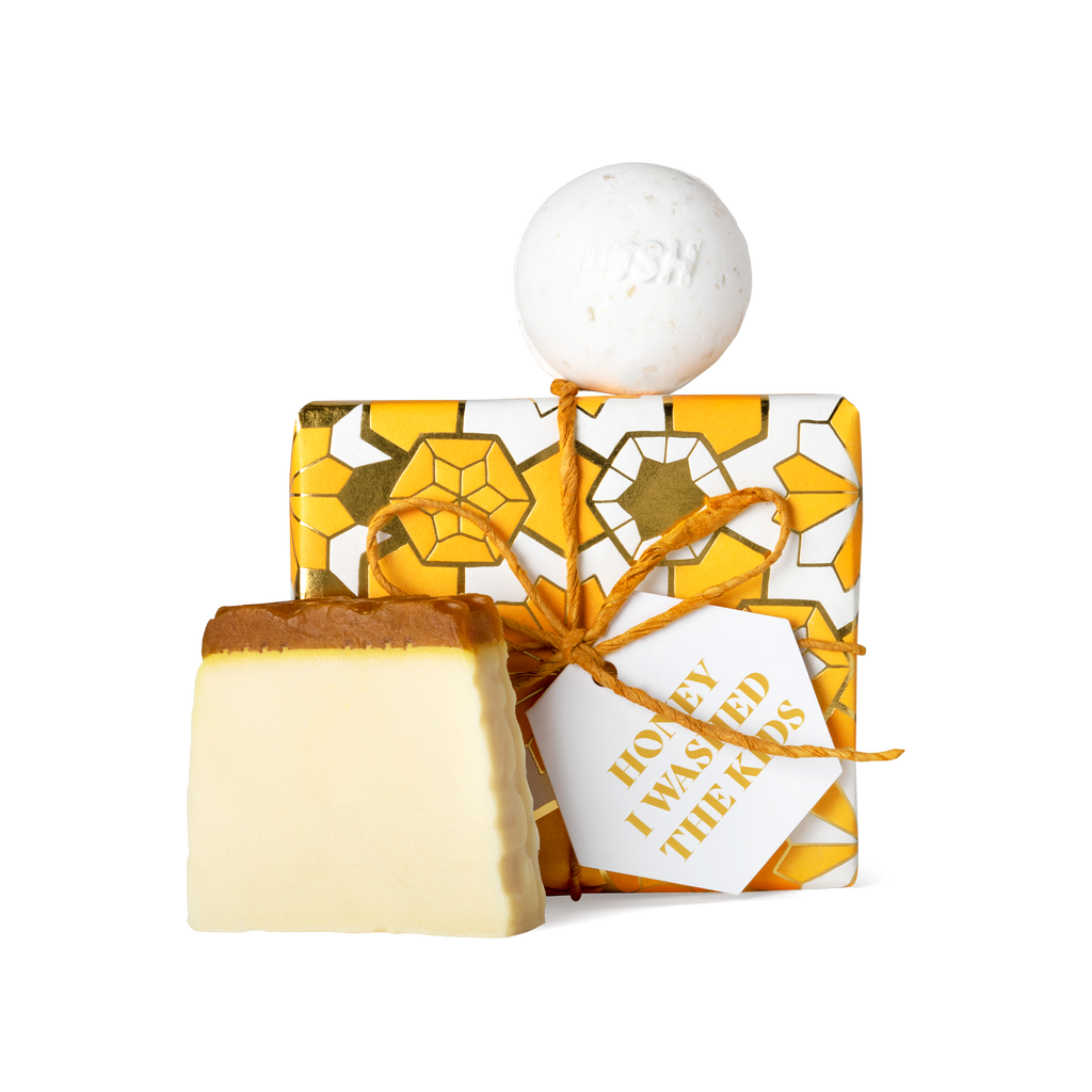 Honey I Washed the Kids. A square box, wrapped in white, yellow, and gold Khadi paper, tied with gold string and gift tag.
