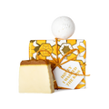 Honey I Washed the Kids. A square box, wrapped in white, yellow, and gold Khadi paper, tied with gold string and gift tag.