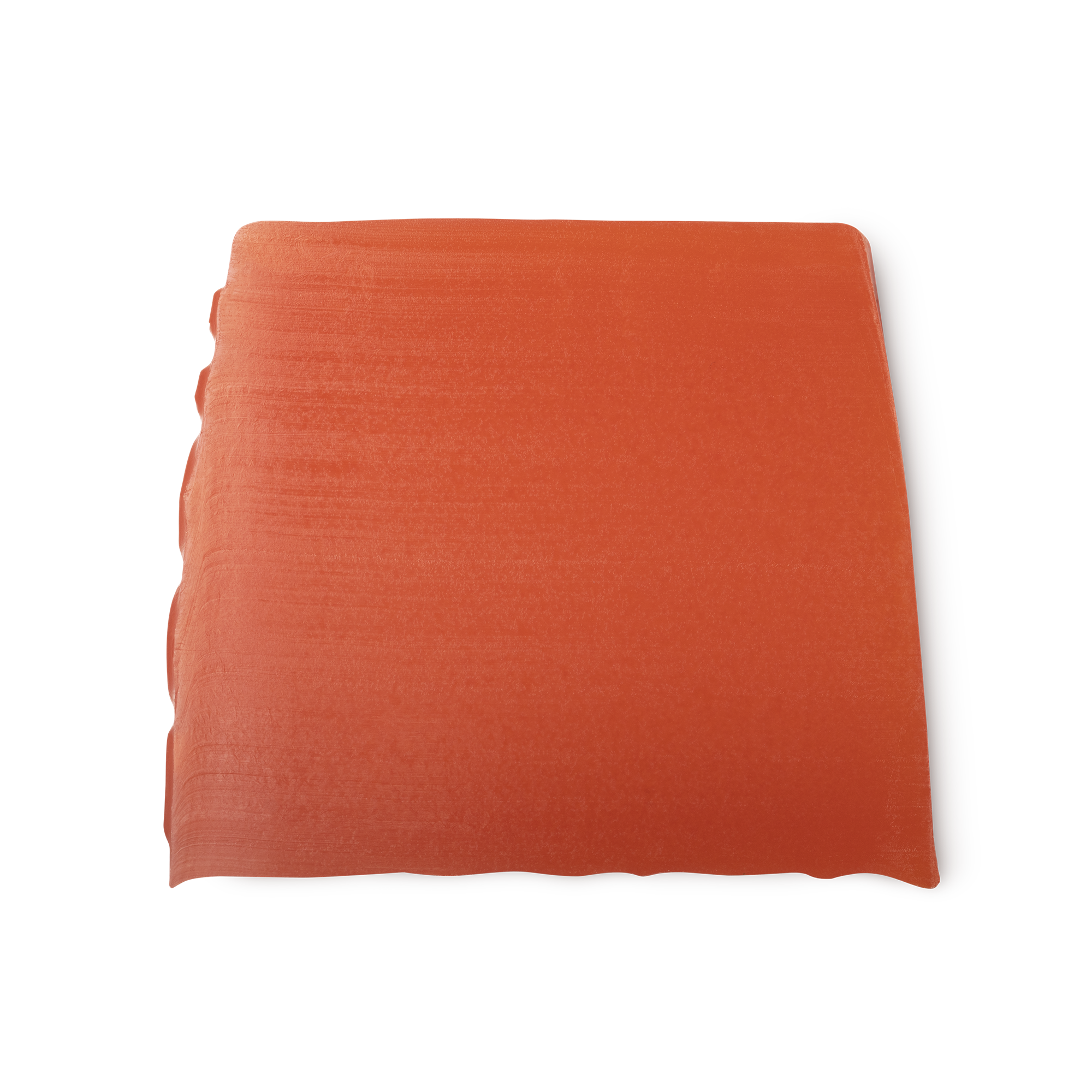 Karma. A deep orange, smooth, trapezium shaped soap, with bumps along its left side.