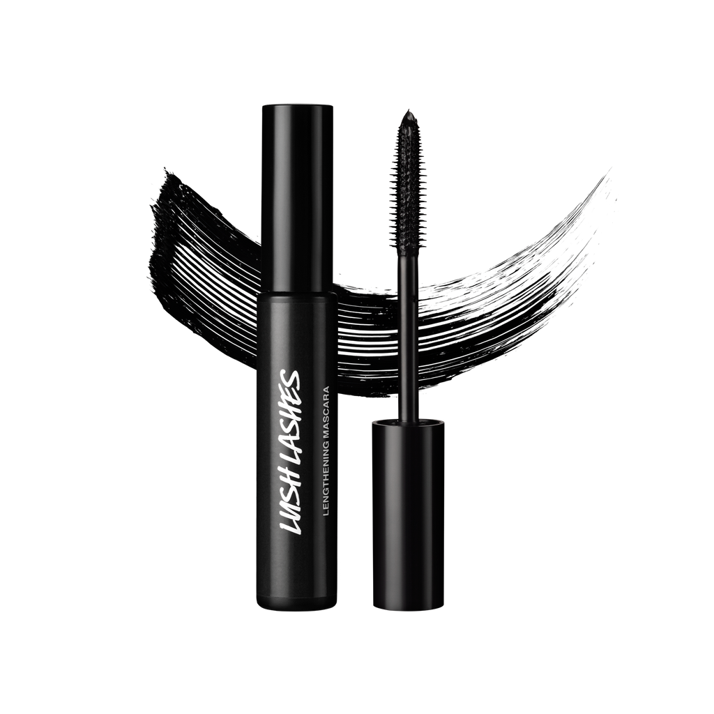 A tube and wand of Lush Lashes mascara, both made of black Lush plastic, are positioned in front of a swatch of black mascara.