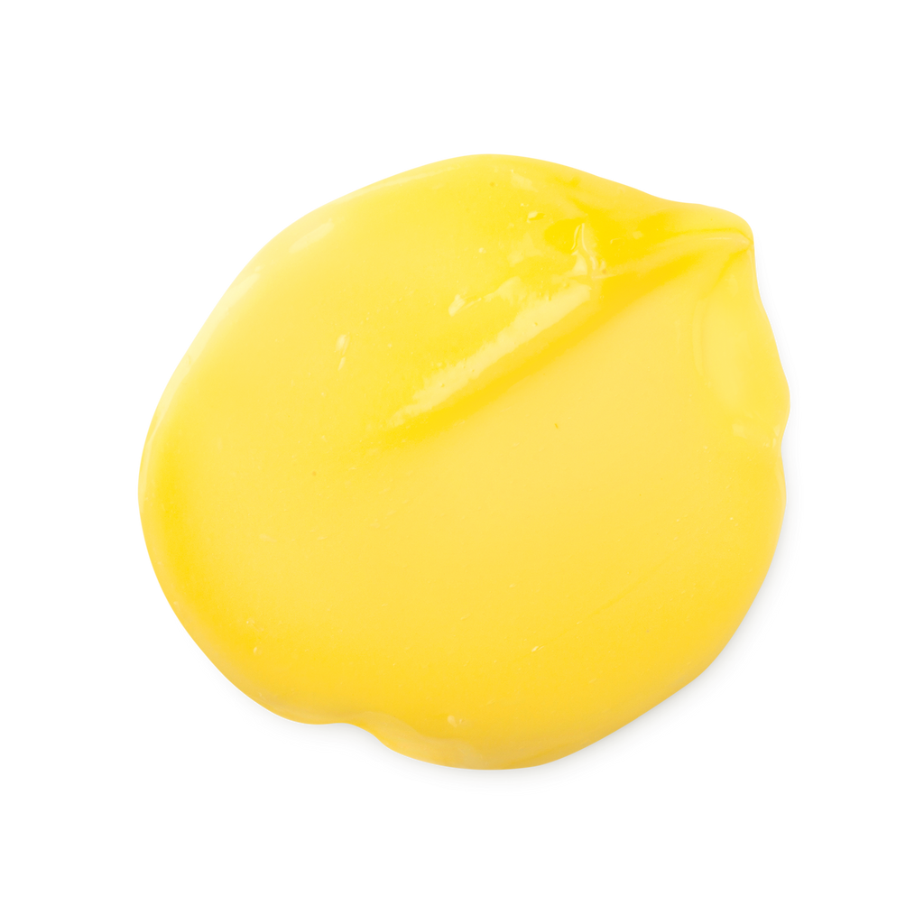 Marilyn. A smooth, round dollop of bright yellow hair treatment. The product has a glossy, fluid texture with subtle folds and a slight peak on one side where it was swirled.