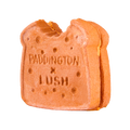 Marmalade Sandwich. A brown, sandwich-shaped bubbleroon bubble bar with a small bite taken out of the top corner. The textured surface features the embossed text ‘PADDINGTON x LUSH’ and bread texture detail.