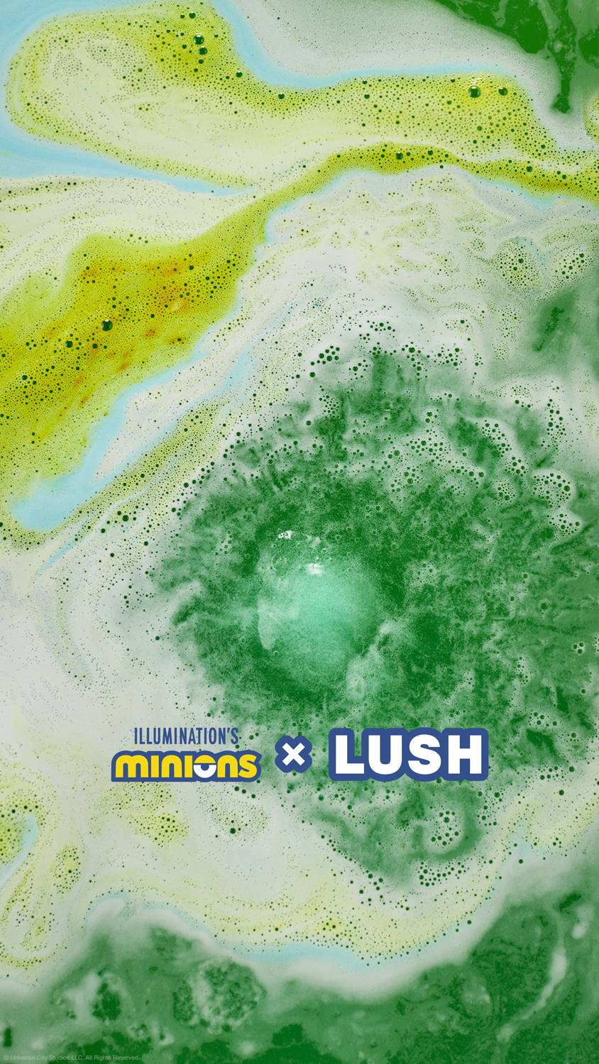 The Minions bath bomb has fully dissolved leaving behind ribbons of blue and green swirling foam. The Minions X LUSH logo at at the bottom.