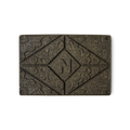 Noir Henna. A brown rectangular block of solid henna hair colour, with a floral design and the letter N pressed on the top.