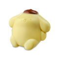 Pompompurin. A glossy, pale yellow shower jelly shaped like the character Pompompurin. The rounded, dog-like figure has a small brown beret on its head and is shown from a slight angle.