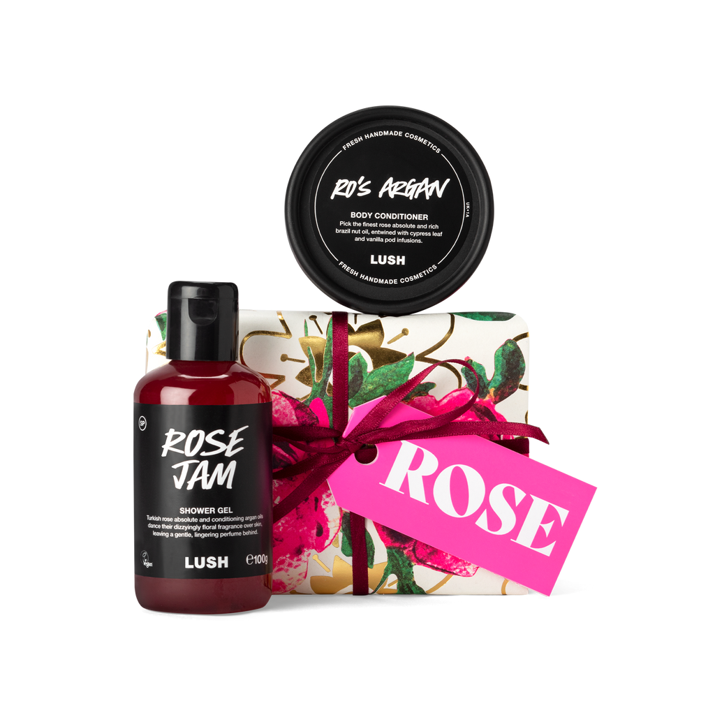 Rose. A small, rectangular box, wrapped in white, rose printed Khadi paper, tied with a burgundy ribbon and a pink gift tag.