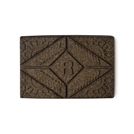 Rouge Henna. A brown rectangular block of solid henna hair colour, with a floral design and the letter R pressed on the top.