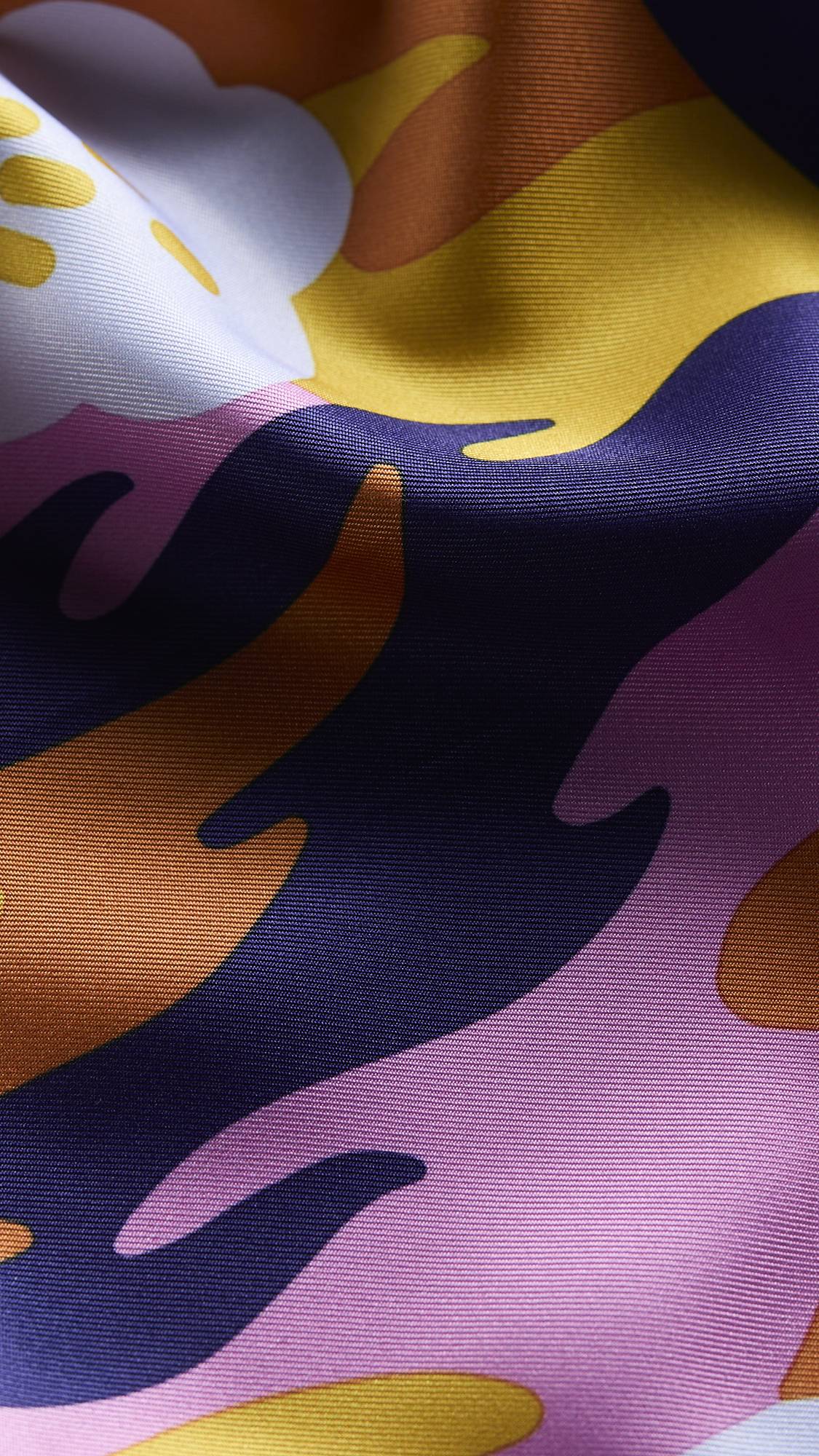 The image shows a super close-up image of the knot wrap. The shot is focused on the texture of the material and the vibrancy of the colours included.