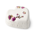 Tisty Tosty. A white, heart shaped bath bomb, topped with dried rosebuds, and a loving inscription running along its side edge.