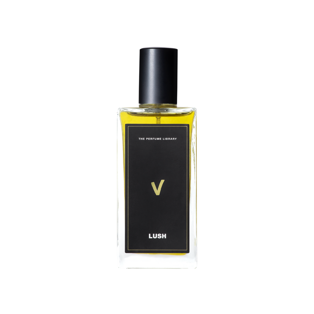 A glass perfume bottle filled with greeny-yellow liquid. A black label reads 'The Perfume Library' and 'V'.