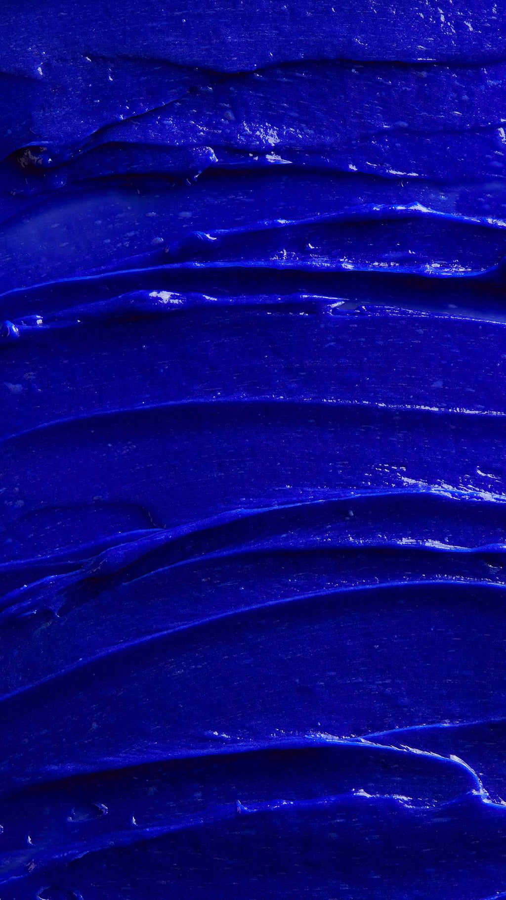 Image is a very defined close-up of the vivid violet shampoo spread covering the screen like a sea of thick blue batter.