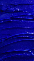 Image is a very defined close-up of the vivid violet shampoo spread covering the screen like a sea of thick blue batter.