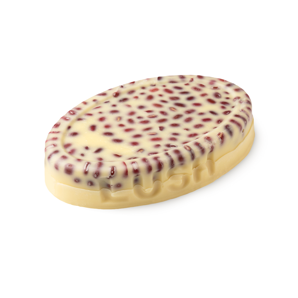 Wiccy Magic Muscles. A buttery yellow, oval shaped, solid massage oil bar, with LUSH imprinted on its edge,