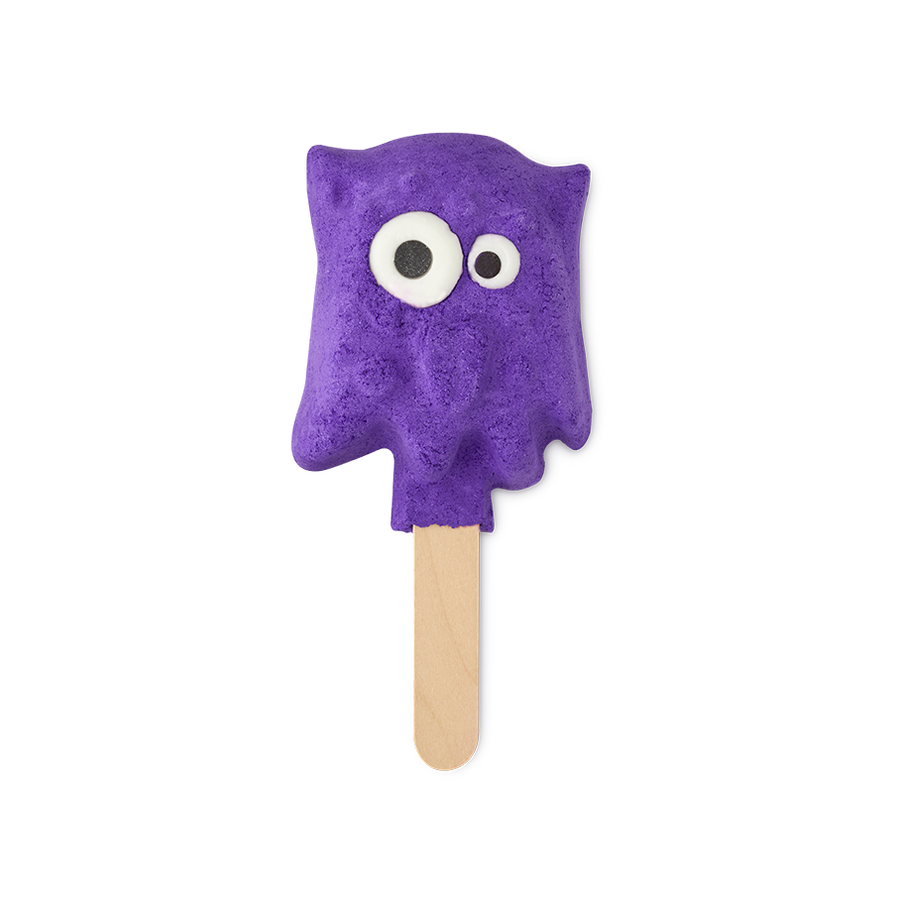 Worry Monster. A fun, bright purple bubble bar in the shape of a non-uniformed blob with a pair of mismatched bright eyes. The bubble bar is attached to a wooden stick, looking almost ice-lolly-like.
